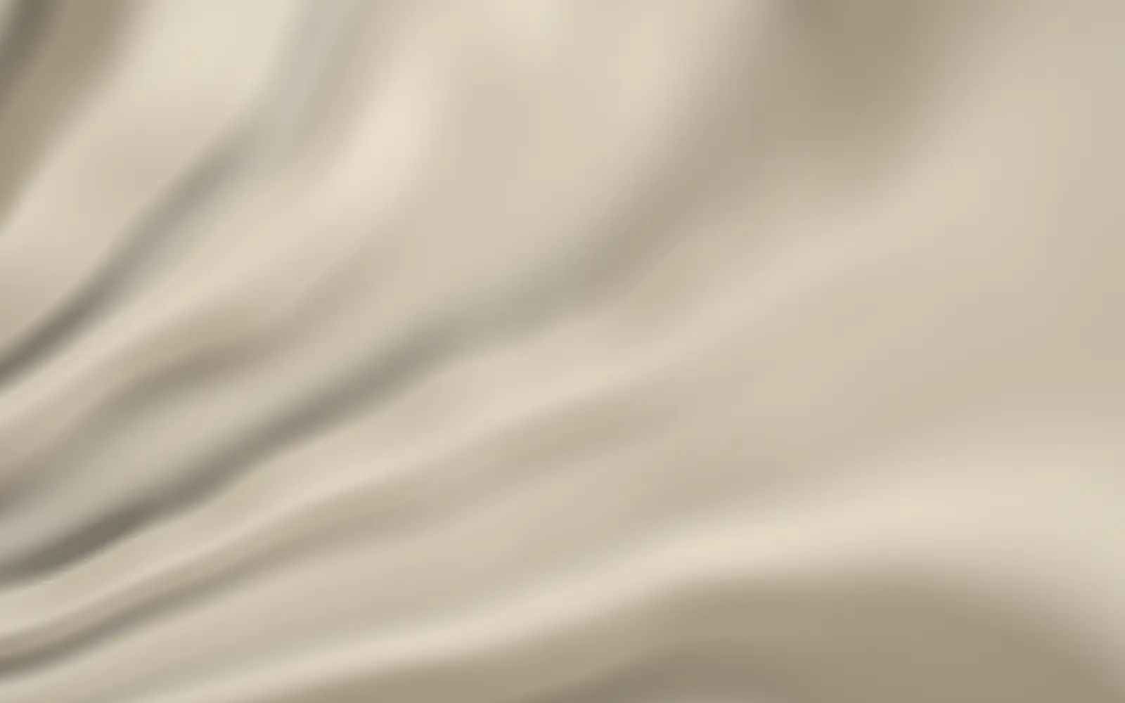 Drawn ivory silk caught mid-fall, light tracing its sheen.