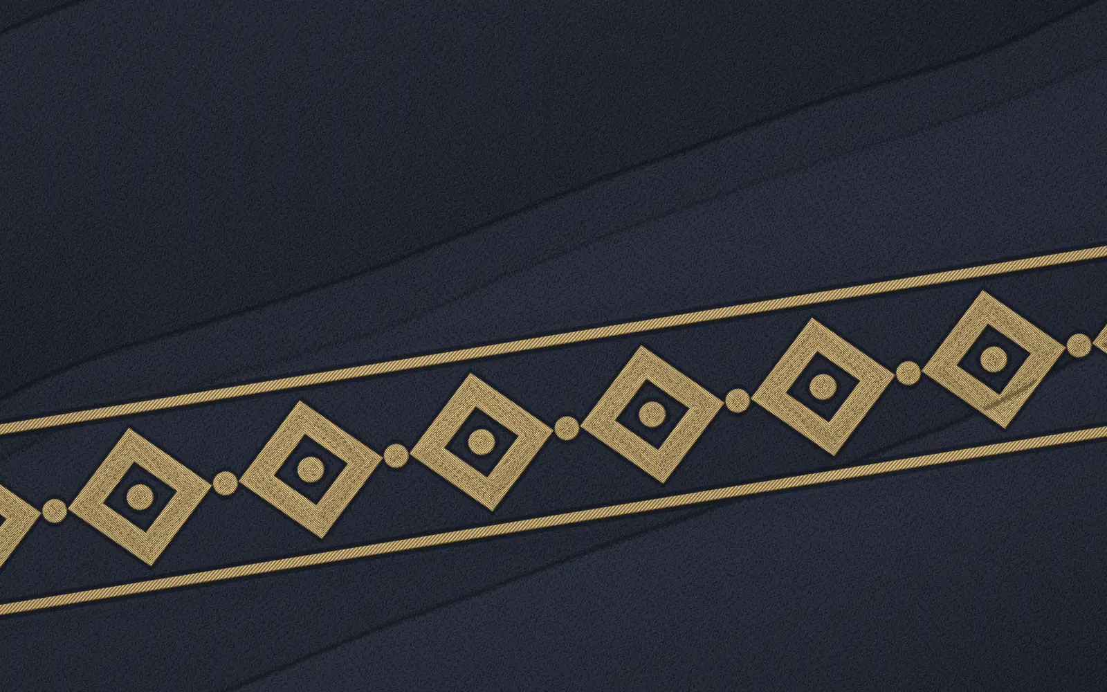 Drawn close detail of gold embroidered trim on midnight crepe.